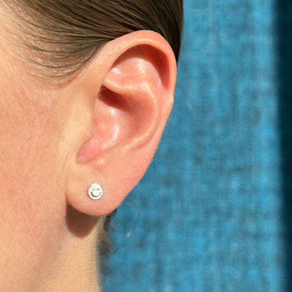 Silver smiley face stud earrings, single or pair
